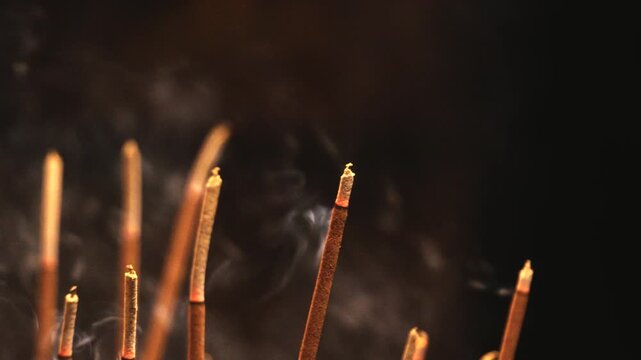 Incense Sticks Slowly Burning in Temple Censer Releasing Smoke