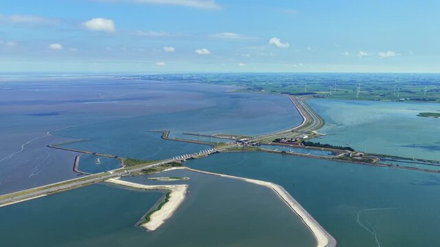 Aerial view of the Vismigratierivier fish migration river at the Afsluitdijk dam with calm water and coastal landscape in Kornwerderzand, Friesland, Netherlands.