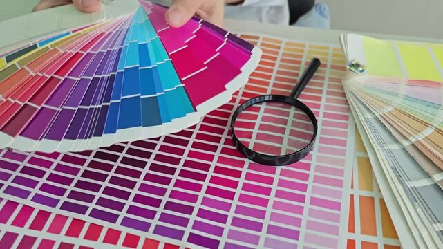 Exploring color samples and color matching with a magnifying glass in a design studio