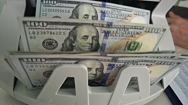 Counting money with a cash counting machine in a busy bank office