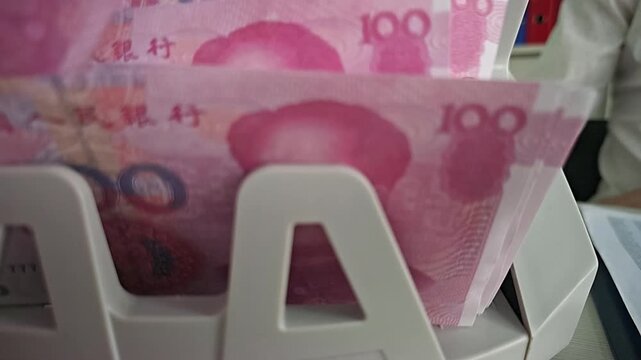 Counting money in a bank during business hours in a busy city