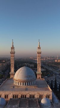 Scenic aerial drone view of an Islamic mosque at sunrise. Urban landscape during the holy month of Ramadan and Eid
