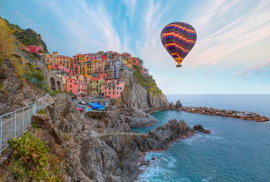 Hot air balloon flying over Cinque Terre, traditional Italian architecture - Manarola is a small town in the province of La Spezia, italy