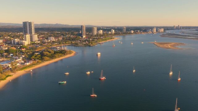 Horizontal aerial footage panning right while trucking left over the Southport Broadwater and Surfers Paradise, Gold Coast, Queensland, Australia