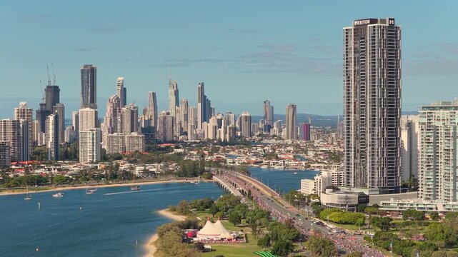 Horizontal aerial footage hovering over Sundale Bridge, Southport and the Gold Coast Marathon with the Surfers Paradise skyline, Gold Coast, Queensland, Australia