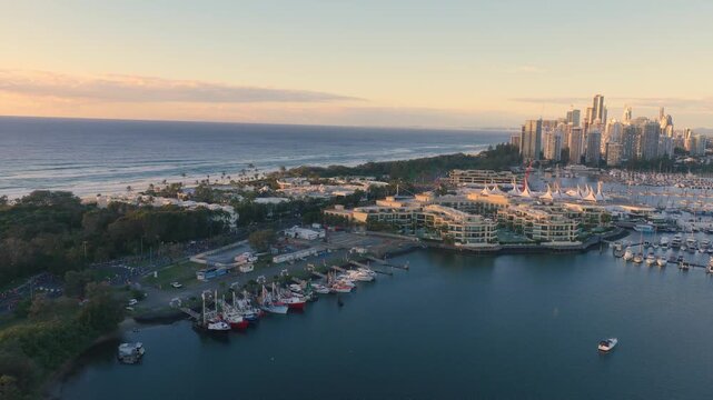 Horizontal aerial footage dollying forward while panning left over Southport, Surfers Paradise and the Gold Coast Marathon, Queensland, Australia