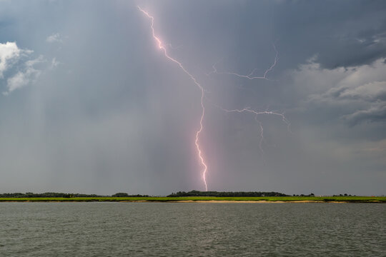 Lightning strikes over the water in Beaufort SC during a storm in late afternoon