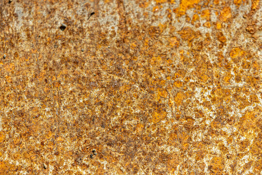Close-up texture of weathered, rusty metal surface with orange and brown hues, background, texture