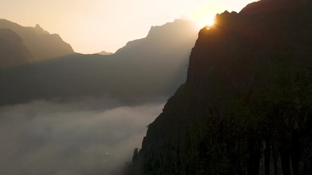 Aerial view of the misty slopes of Gunung Kelud at sunrise in Kecamatan Ngancar, Jawa Timur, Indonesia.