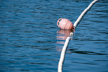 Reddish buoy floating on the sea. © goodcatfelix