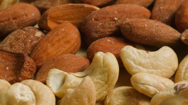 Nuts mix of pecan walnut cashew hazelnut pine and Brazil nuts with peanut on wooden table healthy snack close-up