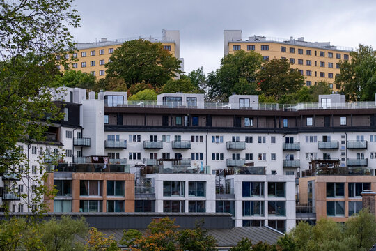 Residential buildings in Oslo combine modern architecture and apartment balconies with urban housing layered among trees across a dense city neighborhood