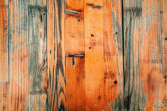 Rustic wooden plank surface with visible finger joints, natural knots and rich amber grain. Warm wood texture ideal for carpentry, furniture design, interior decor and rustic backgrounds.