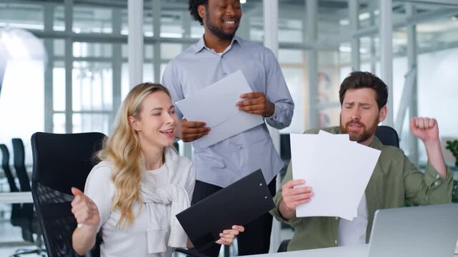 Positive successful happy multiracial business team dancing holding papers singing celebrating conclude contract teamwork multiethnic businessmen with businesswoman hold documents dance sing in office