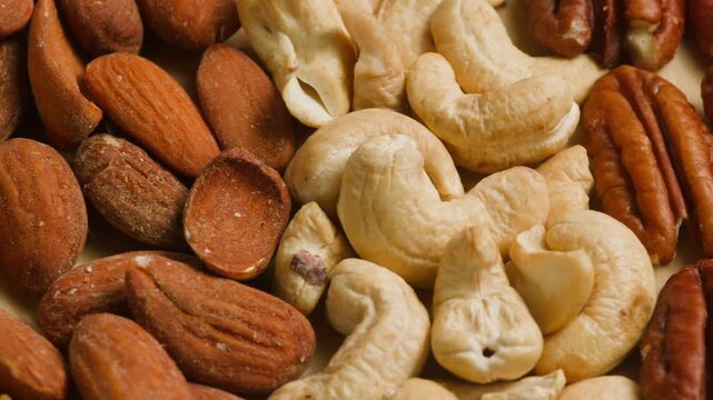 Nuts mix of pecan walnut cashew hazelnut pine and Brazil nuts with peanut on wooden table healthy snack close-up