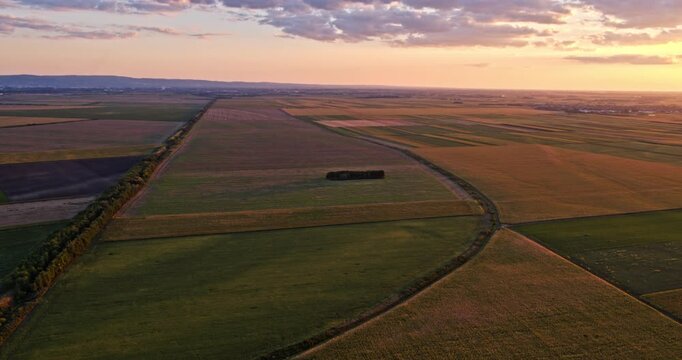 Aerial view of agricultural fields and farmland during a picturesque sunset