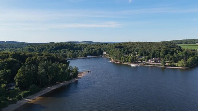 Lac des Settons, a scenic lake surrounded by lush green forests in the Morvan region of France, aerial view.