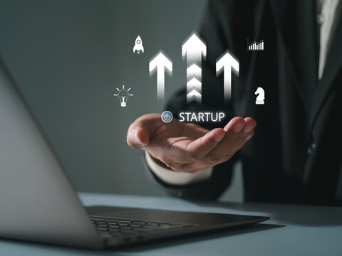 The startup business concept using a digital tablet virtual screen includes an activation icon and organizational growth strategy.