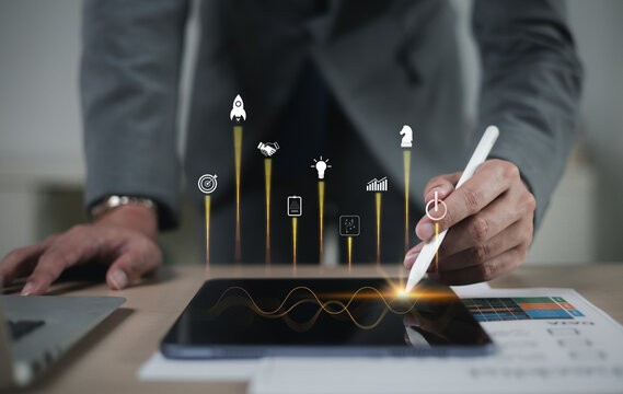 The startup business concept using a digital tablet virtual screen includes an activation icon and organizational growth strategy.