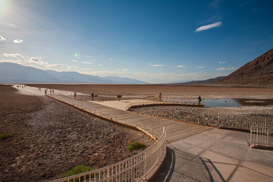 Beautiful scenic view of Badwater Basin boardwalk with tourists in Death Valley