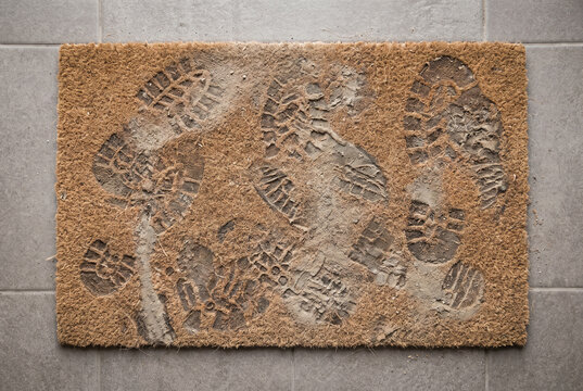 Coir Doormat With Muddy Footprints and Entrance Mess