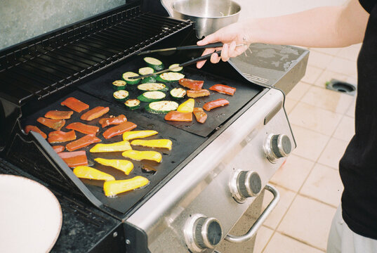Anonymous person making grilled vegetables