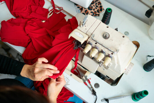 Overhead view of woman sewing fabric