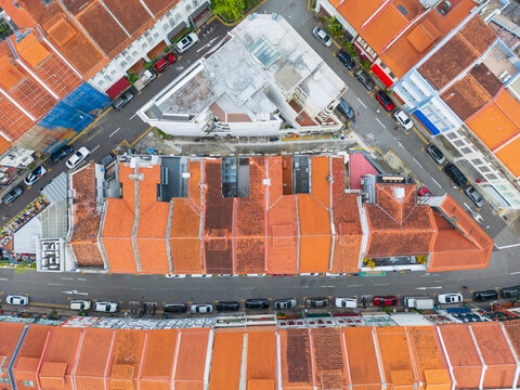 Traffic on roads between row hoses with terracotta tiled roofs