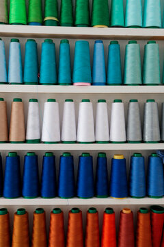 Colorful sewing threads on shelves