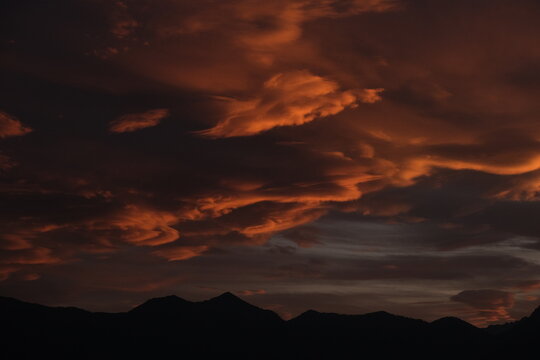Dramatic sunset sky above alpine mountains near Lake Garda
