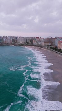Aerial view of orzan beach with atlantic ocean waves crashing