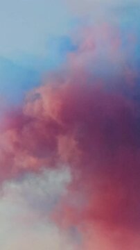 Colorful clouds move across the sky at sunset with shades of pink, blue, and orange appearing together
