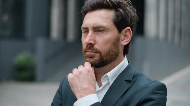 Close up pensive Caucasian middle-aged business man thinking idea looking at camera in city thoughtful hesitate formal businessman think solution in downtown male employer serious pondering decision