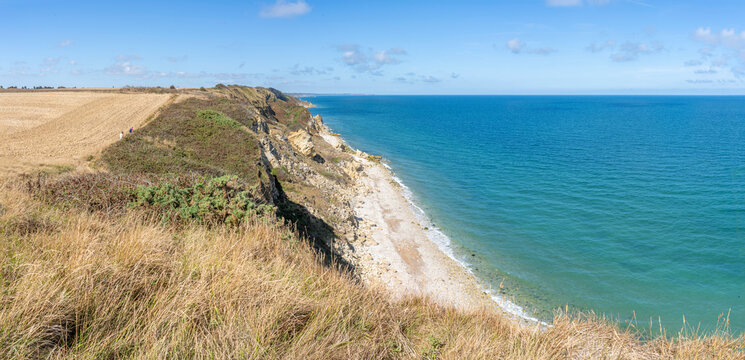 Arromanches-les-Bains, France - 08 10 2026: Coastal path. Panoramic view of the cliffs, the sea and cloudy sky from top of the path