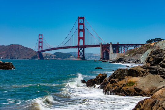 Waves crashing against rocks near the Golden Gate Bridge in San Francisco
