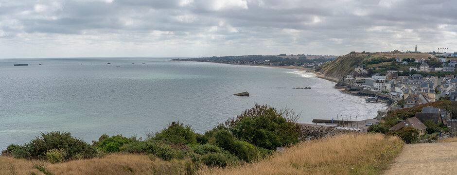 Arromanches-les-Bains, France - 08 10 2026:  Normandy landing blockhouse. Panoramic view of the artificial port with pontoons bridges, the beach, the sea, cliffs and the city from coastal path