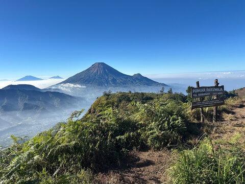 The beauty of nature and Mount Sindoro in Indonesia, set against a clear blue sky. This view is seen from Mount Pakuwaja.