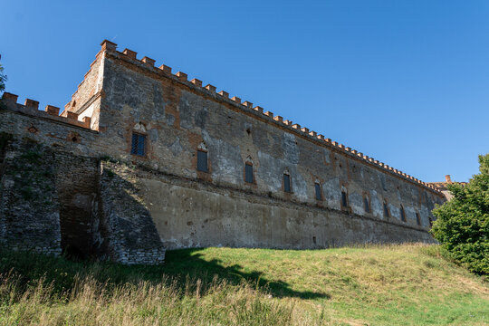 Long medieval stone wall of Medzhybizh fortress with brick battlements