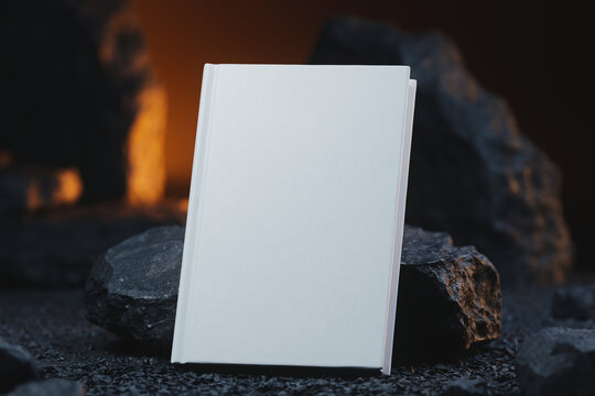 Dramatic 3D render of a white hardcover book leaning against a natural stone in warm moody lighting. Macro mockup with copy space for book cover design, catalog, and luxury stationery presentation.