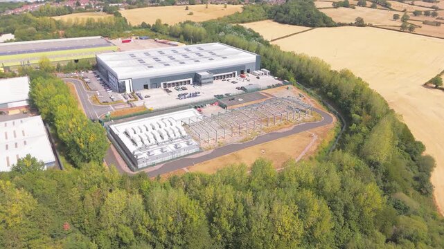 An aerial forward push in drone movement of a new data centre with ultra low power usage effectiveness cooling units on the top