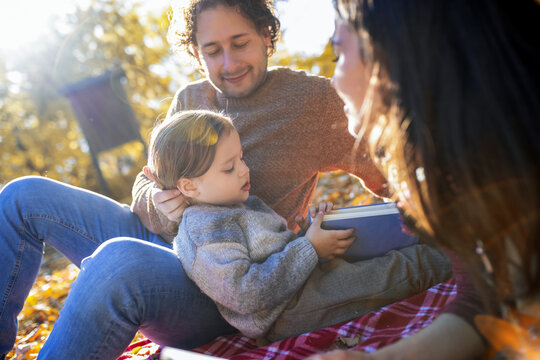 Close-up of family talking on autumn picnic