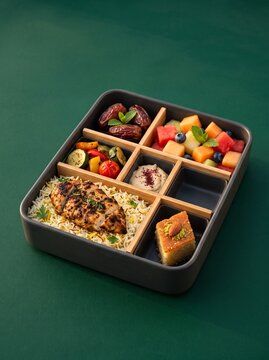 Colorful wooden board game with red dice and brown game pieces on green background.