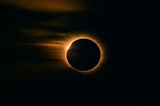 Diamond ring effect at the end of totality, bright bead of sunlight bursting from the moon edge with corona and clouds, total solar eclipse of 12 August 2026, Mallorca, Spain
