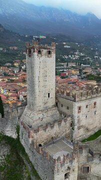 Aerial view of Scaliger Castle perched on a rocky cliff above Malcesine and Lake Garda