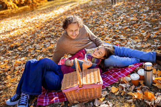 Mother and son hugging on autumn picnic blanket