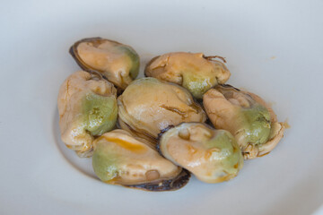 Ready-to-eat mussels on a clear plate. © Ana Maria