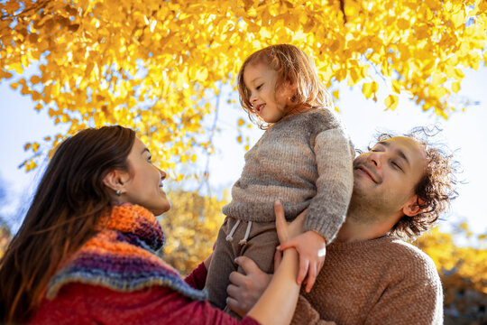 Happy mother and son looking at each other in park