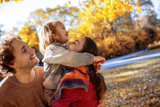 Close-up of parents holding son on autumn walk