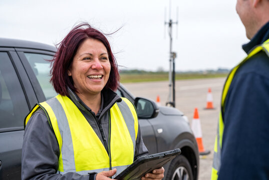 Airfield safety briefing with woman holding tablet