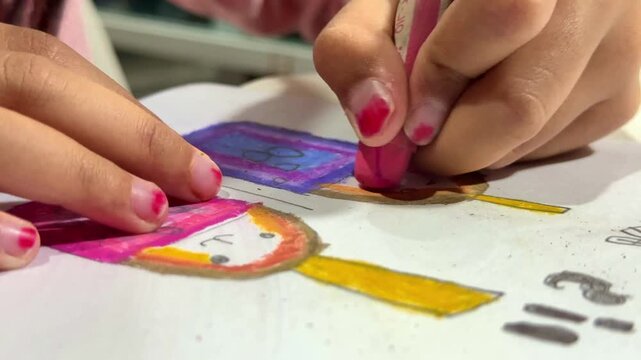little girl's hand using crayons to color drawing, childhood creativity, kids art homework, colorful artwork background.